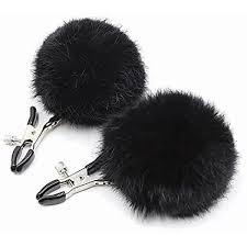 Black nipple clamps with soft rubber tips and large fluffy black puff ball accents.