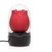 Red rose-shaped stimulator inside a clear protective case with a black base and USB charging cable.