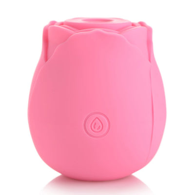 Pink silicone rose-shaped clitoral suction stimulator with a single button on the front, designed for discreet pleasure.