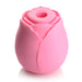 Pink rose-shaped silicone clitoral suction stimulator with a central suction hole and smooth petal design.