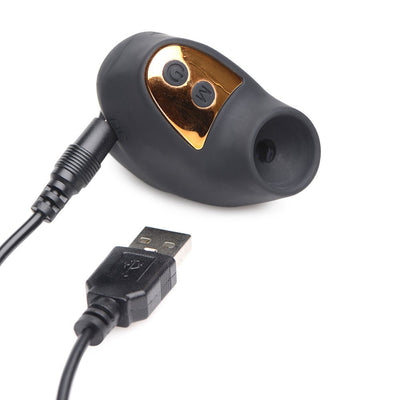 Black and gold mini suction clitoral stimulator with USB charging cable on white background.