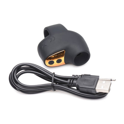 Black and gold mini suction clitoral stimulator with USB charging cable on white background.