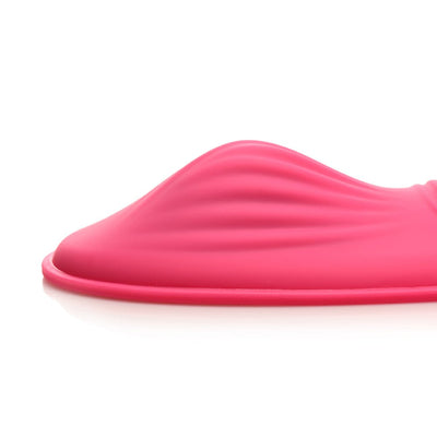 Close-up side view of the pink silicone ribbed grinding pad with a raised mound detail on a white background.
