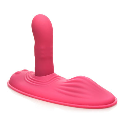 Pink silicone hands-free grinding pad with ribbed texture and rotating shaft for versatile stimulation.