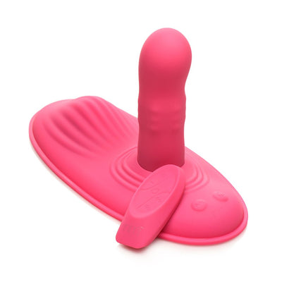 Pink silicone hands-free grinding pad with rotating shaft and remote control on white background.