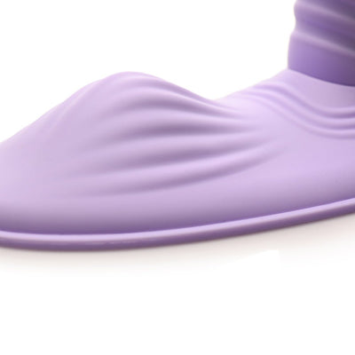 Close-up of the soft, textured purple silicone surface of the Inmi Thrust N Grind pleasure device.