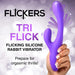 Hand holding a purple silicone Tri Flick rabbit vibrator with flicking and vibrating features highlighted.