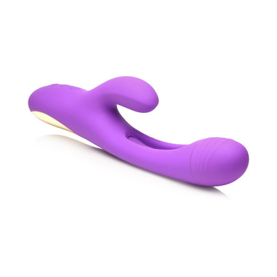 Purple silicone Tri-Flick rabbit vibrator with curved shaft, textured flicking arm, and wide clitoral stimulator.