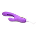 Purple rechargeable silicone rabbit vibrator with curved shaft and flicking arm, shown plugged in for charging.