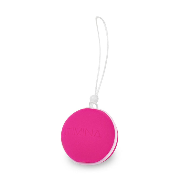 Pink and white Intimina Laselle advanced weighted pelvic floor exerciser ball with retrieval loop.