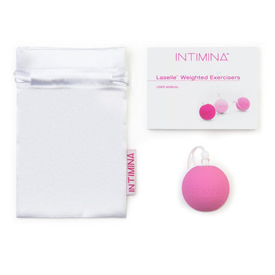 Intimina Laselle Medium 38g pink weighted Kegel ball with white storage pouch and user manual on white background.