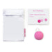 Intimina Laselle Medium 38g pink weighted Kegel ball with white storage pouch and user manual on white background.