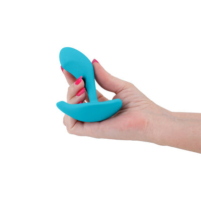 Hand holding a blue silicone Inya Eros Couples Vibrator with a curved, ergonomic design.