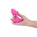 Hand holding a bright pink silicone Inya Eros Couples Vibrator against a white background.