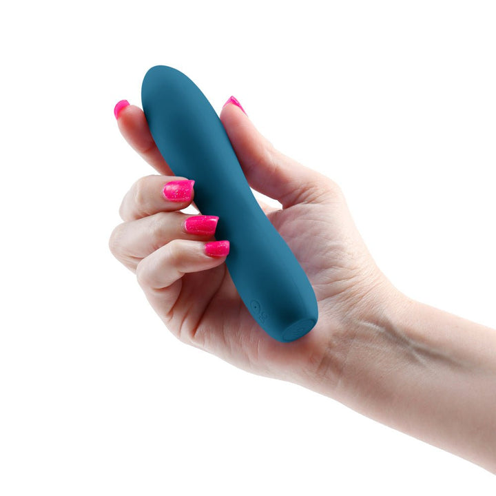 Hand holding a compact, teal silicone Inya Ruse vibrator with a smooth, curved design and control buttons.