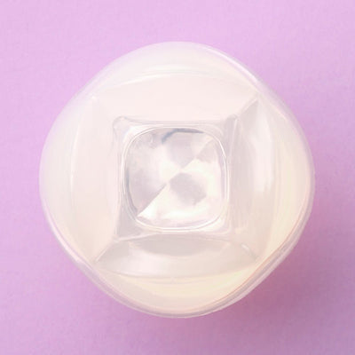Top view of the translucent iroha Petit LILY Clear personal massager on a lavender background.