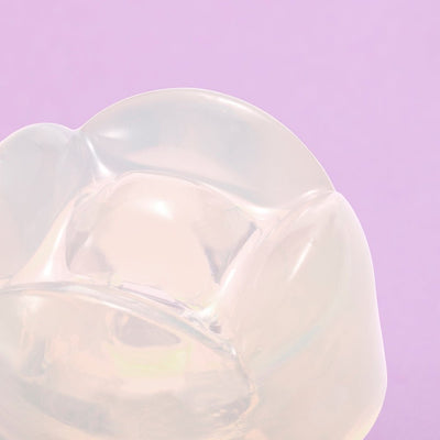 Close-up of the translucent iroha Petit LILY Clear pleasure item with soft, rounded edges on a lavender background.