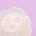 Close-up of the translucent iroha Petit LILY Clear pleasure item with soft, rounded edges on a lavender background.