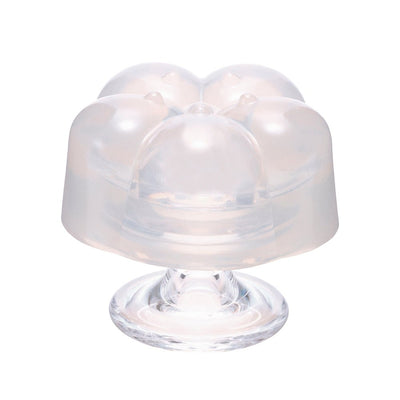 Transparent flower-shaped compact moisturizer container with a rounded base and soft curves.