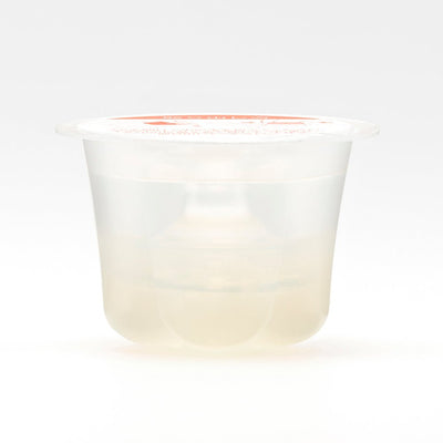 Compact clear single-use moisturizer cup with a sealed lid for on-the-go hydration.