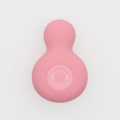 Top view of pink Iroha Yuki Nadeshiko Color personal massager with smooth, rounded shape and central control button.