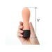 Hand holding a 5-inch compact Iroha Zen mini vibrator with textured silicone body and black base.