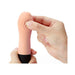 Hand holding a compact, textured peach-colored Iroha Zen mini vibrator with a black base against a white background.