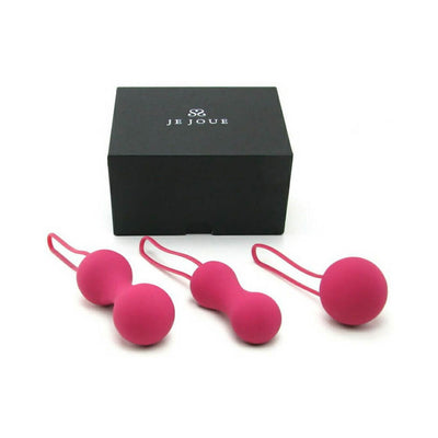 Set of three fuchsia silicone kegel balls with ergonomic loops displayed in front of a black Je Joue branded box.