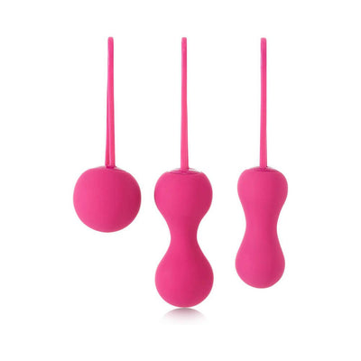 Set of three fuchsia silicone Kegel exercise weights with ergonomic finger loops for pelvic floor training.