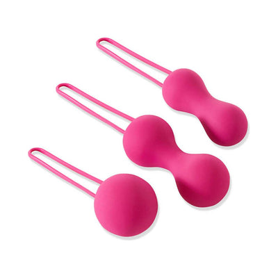 Set of three fuchsia silicone kegel balls with ergonomic finger loops for pelvic floor exercise and toning.