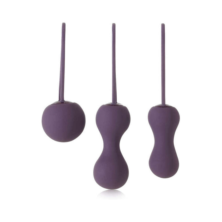 Set of three purple silicone kegel exercisers in varying shapes and sizes with ergonomic retrieval loops.