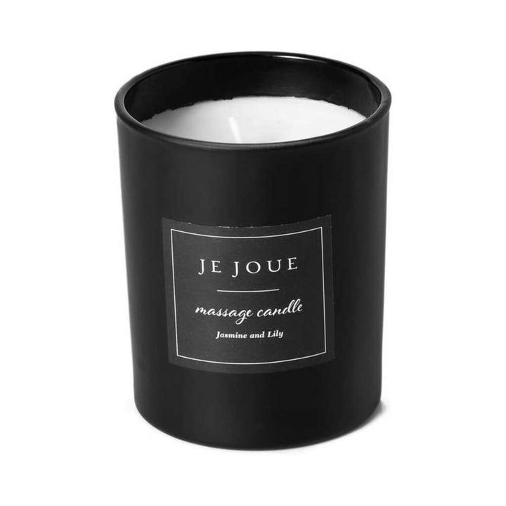 Je Joue black glass massage candle with white wax and jasmine and lily scent label.