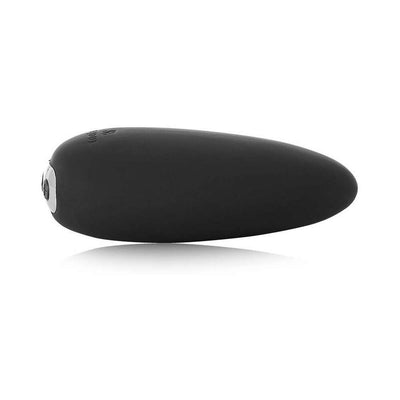Black sleek pebble-shaped Je Joue Mimi Soft clitoral vibrator with smooth silicone surface and rounded tip.
