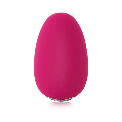 Pink pebble-shaped Je Joue Mimi Soft clitoral vibrator with smooth silicone surface and subtle logo embossing.