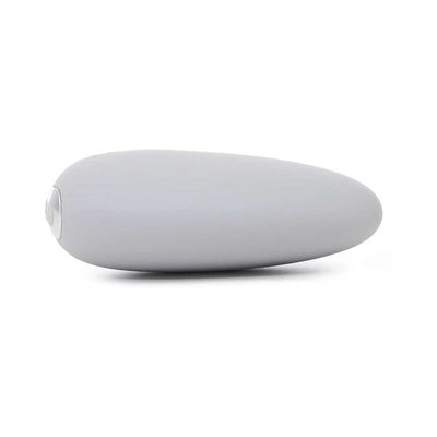 Smooth gray pebble-shaped clitoral vibrator with soft tip and single button control on white background.