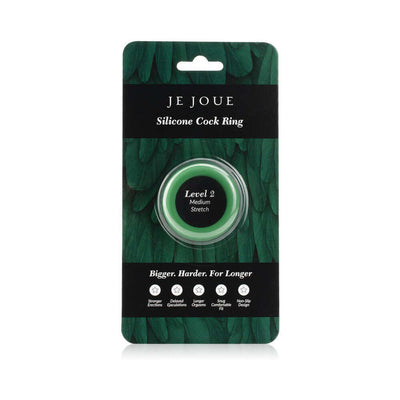 Je Joue medium stretch green silicone ring in clear packaging with black and green feather design background.