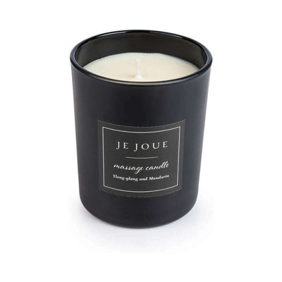 Je Joue black massage candle with ylang-ylang and mandarin scent in a sleek matte glass container.