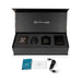 Je Joue The Naughty Collection gift set open with intimate card game, black vibrator, massage candle, restraint, manuals, and USB charger.