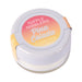 Small white jar of Jelique Pina Colada flavored nipple nibblers balm with gradient pink and yellow label on lid.