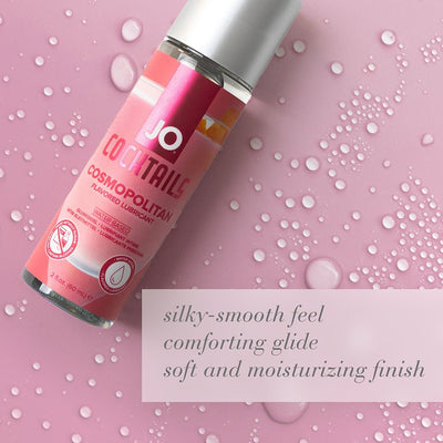Jo Cocktails Cosmopolitan flavored water-based lubricant bottle on pink background with water droplets and product benefits text.
