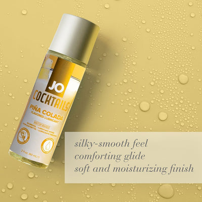 Jo Cocktails Piña Colada flavored water-based lubricant bottle on yellow background with water droplets and product benefits text.