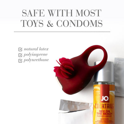 Red silicone vibrating ring with flower detail next to JO Cocktails Sex on the Beach flavored lubricant and condoms, safe with most toys and condoms.