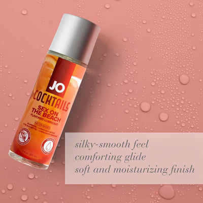 Bottle of Jo Cocktails Sex on the Beach flavored lubricant on pink background with water droplets and product benefits text.