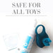 Travel size JO Foaming Toy Cleaner bottle with a blue silicone ring toy and a condom packet on a white background.