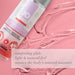 Bottle of Jo Natural Agape Warming water-based personal lubricant on pink textured background with product benefits text.