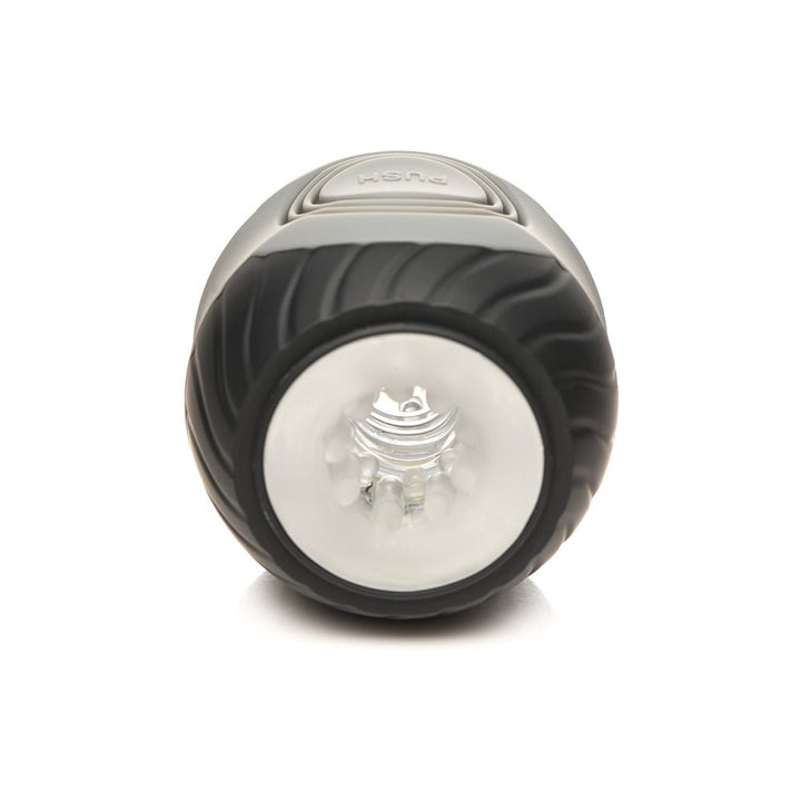 Front view of the Jock 10x Vibrating Double Masturbator showing textured black outer casing and clear inner tunnel opening.