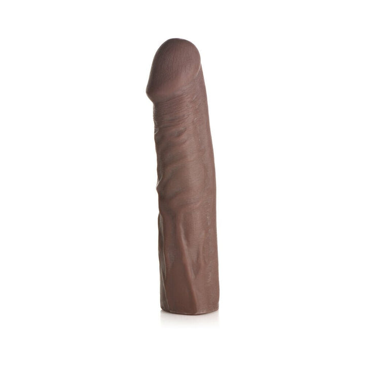 Dark brown extra long penis extension sleeve with lifelike texture and solid tip, standing upright on white background.