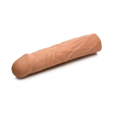 Medium-sized flesh-toned penis extension sleeve with lifelike texture and veining on a white background.