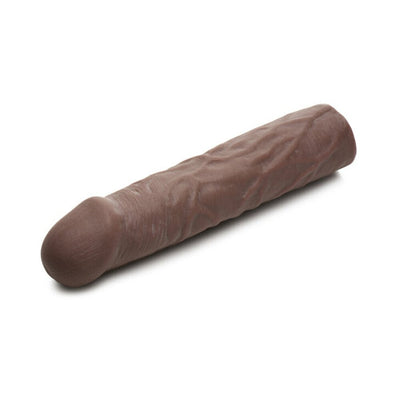 Medium brown flexible penis extension sleeve with lifelike texture and hollow design on white background.