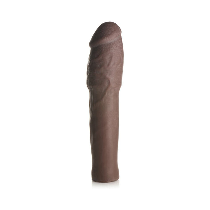 Dark brown extra thick penis extension sleeve with realistic texture and flexible design standing upright on white background.